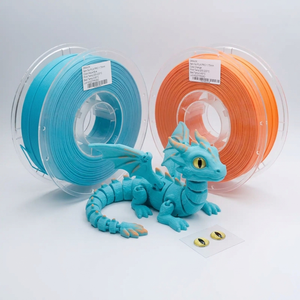 Aqua and orange filament spools behind an articulated dragon, with stick-on eyes in the foreground